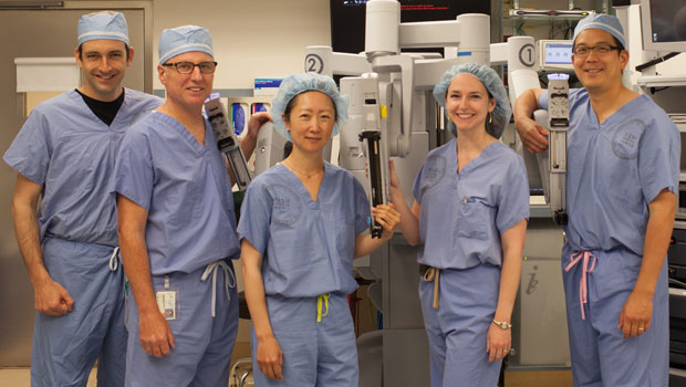 Urology physcians in front of robotics machine