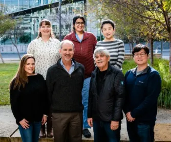 7 people standing outside and smiling at the camera