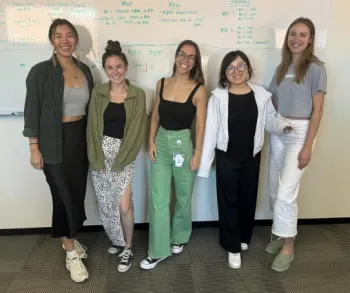 people in front of a dry erase board
