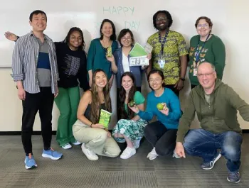 group in front of a dry erase board