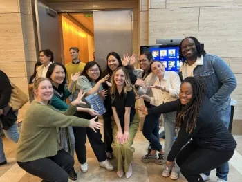 group of people pointing at the person in the middle of the group