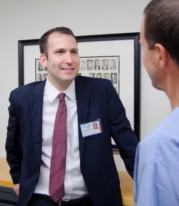 Ben Breyer, MD, MAS, Assistant Professor, speaks with colleague at recent UCSF Urology meeting