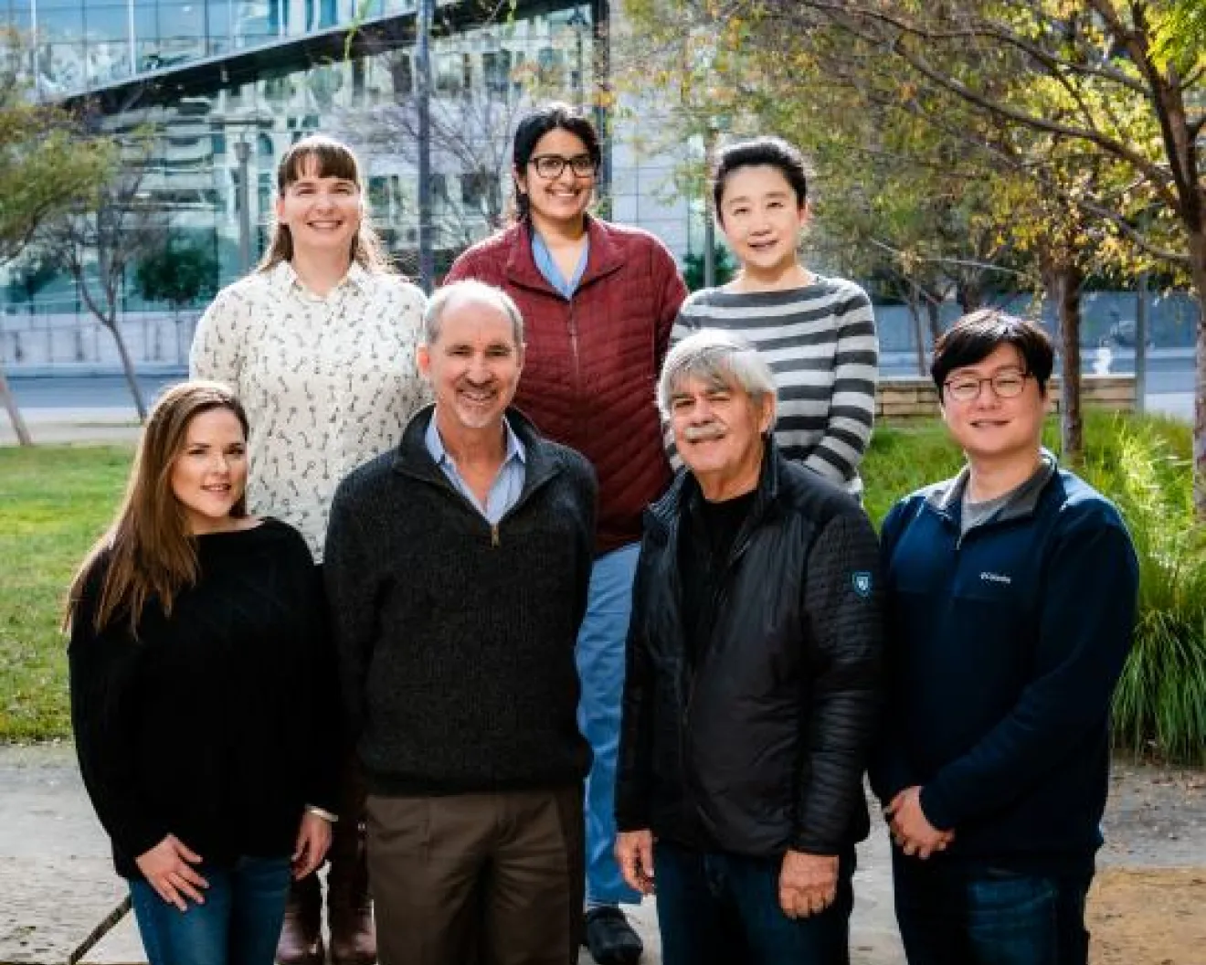 7 people standing outside and smiling at the camera