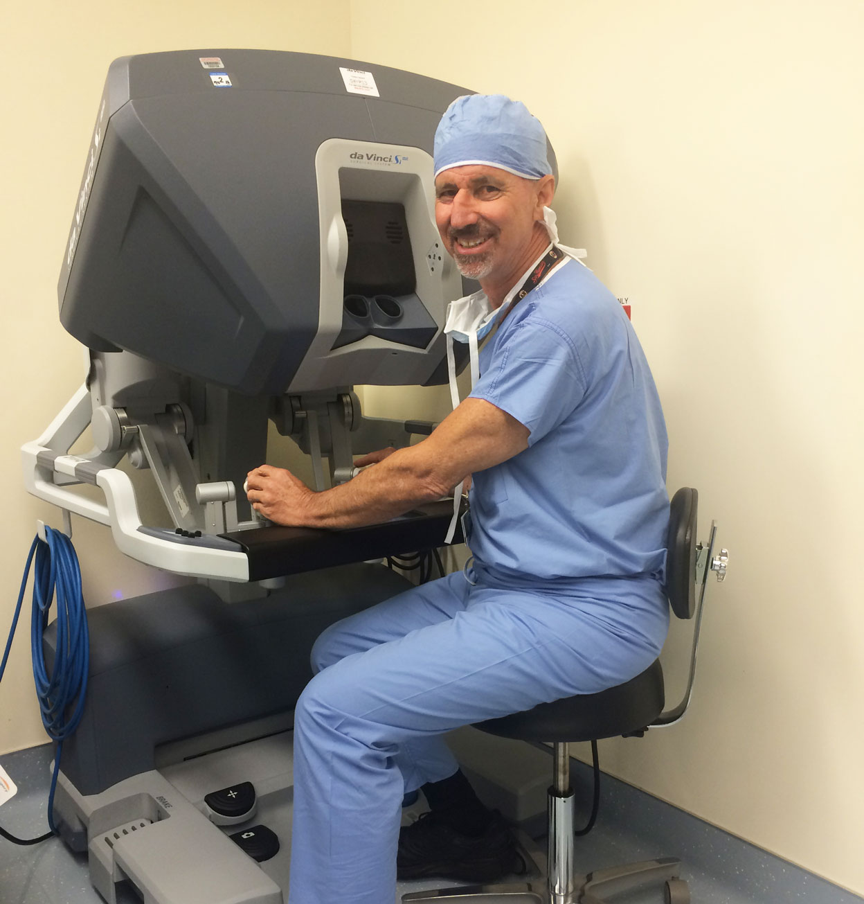 Dr. Baskin controls the robotic instruments from the counsel Dr Baskin with robot